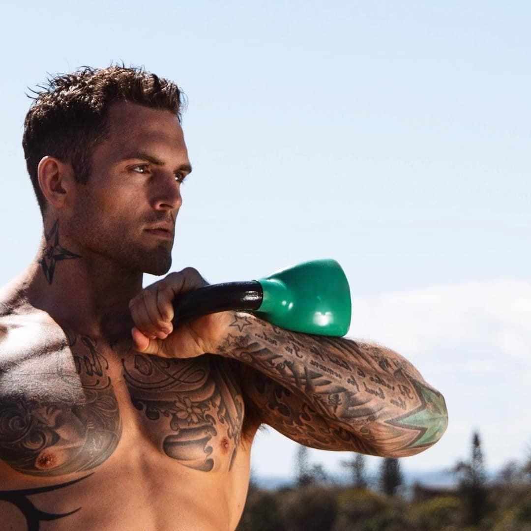 handsome-masculine-shirtless-tattoo-daddy-holding-dumbbells