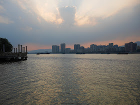 sun setting behind clouds over the Beijiang River in Qingyuan