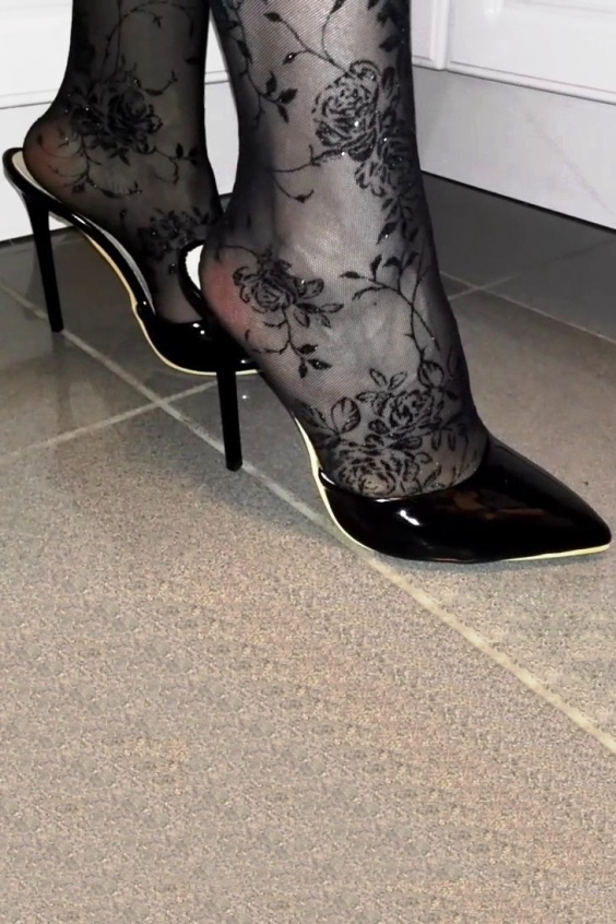 Black shiny pointed mules and black tights