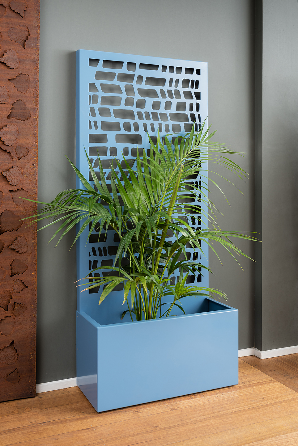 A freestanding screen offering privacy and a generous planter for your