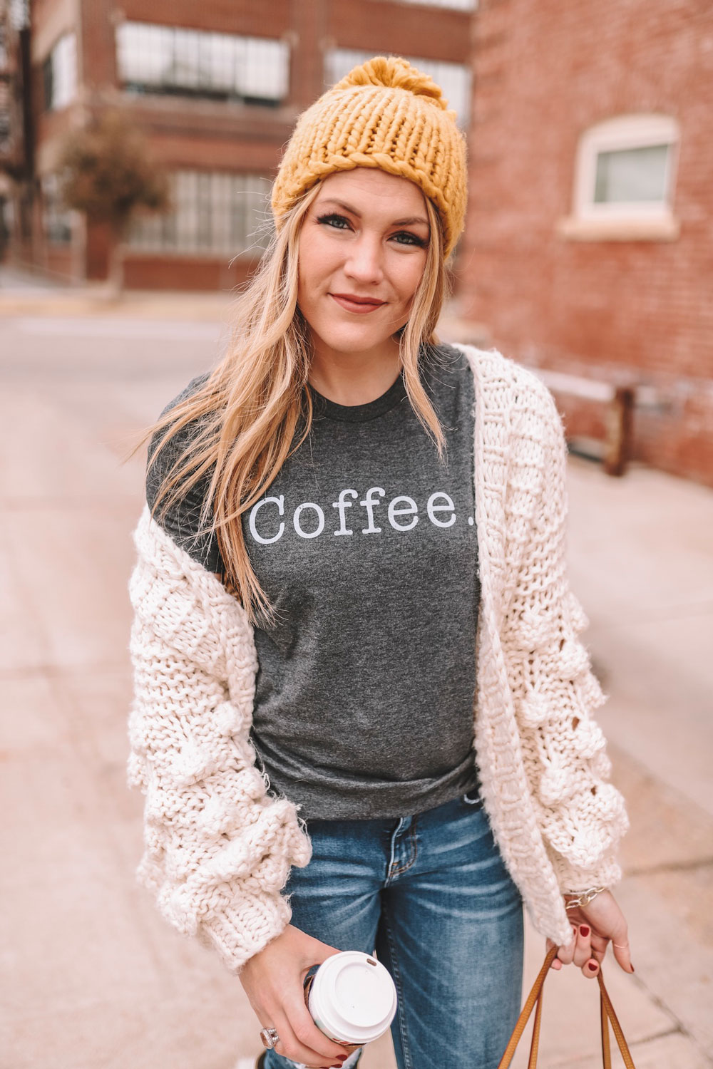 Amanda Martin, Oklahoma City blogger, wears a coffee graphic tee while sipping from a Starbucks holiday cup 