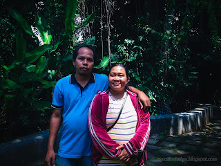 Happy Couple Over Natural Garden Of Balinese Hindu Temple