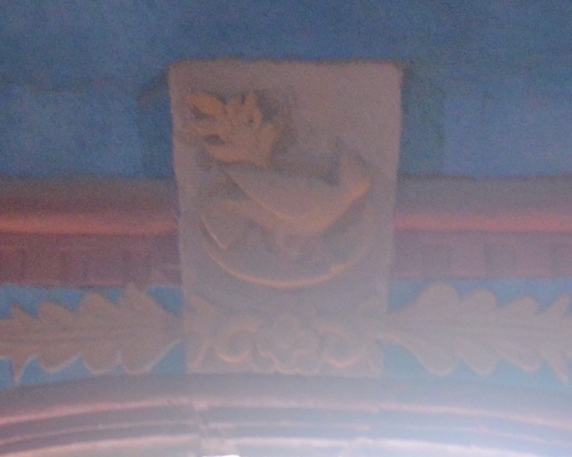 decorative keystone has an image of a partridge on a dish