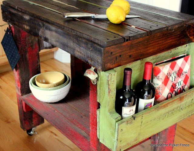book holder, wine rack, pallet wood, DIY, reclaimed, kitchen island, shelf, http://bec4-beyondthepicketfence.blogspot.com/2012/04/pallet-island.html