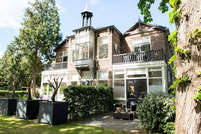A unique Swedish home with a green kitchen and a green sofa