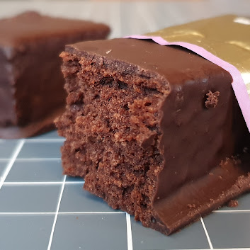 Lo-Dough miracle cake bar open and broken in half to show chocolatey goodness
