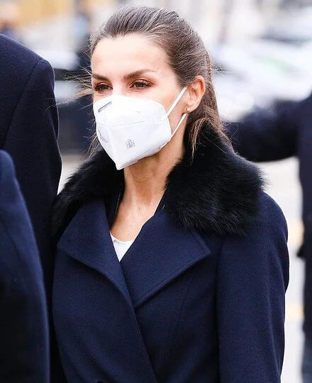 Queen Letizia wore a Canika wool with wrap belt coat from Hugo Boss, and stripe navy trousers and blazer from Boss, and oxford shoes from Uterque