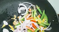 Sauteeing slice onion,bell peppers with ginger garlic green chili for cauliflower Manchurian fried rice recipe