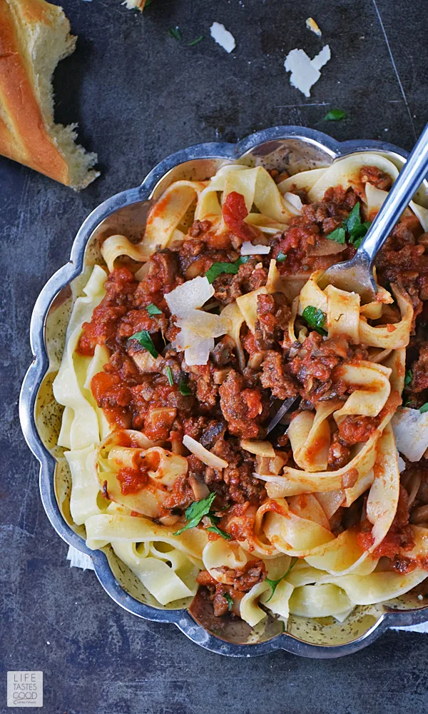 Mushroom Bolognese Pasta Recipe | by Life Tastes Good has a rich, thick, satisfying sauce atop hearty tagliatelle noodles. This recipe is a family style Italian meal that is a fairly easy recipe and fills your home with an irresistible aroma that will bring everyone to the dinner table! #LTGrecipes #SundaySupper