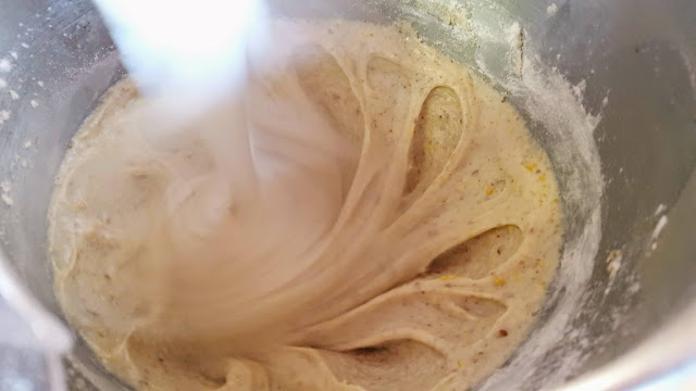 Image Description: A smooth cake-like batter mixed with a blurry standing mixer paddle.