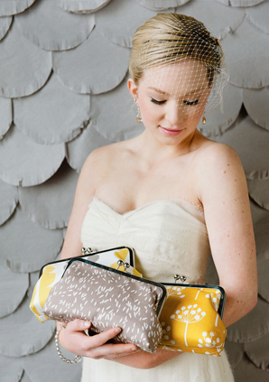 summer bride with an armful of clutches