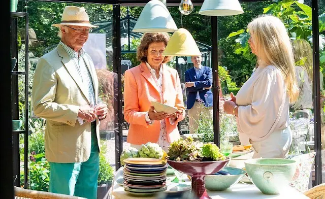 Queen Silvia wore pink blazer and white trousers. Silvia wore a floral print silk blouse