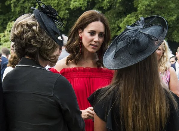 Kate Middleton's dress is by Alexander McQueen Off-the-shoulder shirred cotton and silk-blend. Simone Rocha Crystal earrings, Prada Pumps, Club Monaco Channon Heeled Sandal