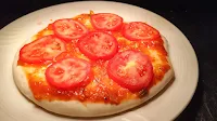 Slice tomatoes over sauce spread pizza  base for Margherita pizza Recipe