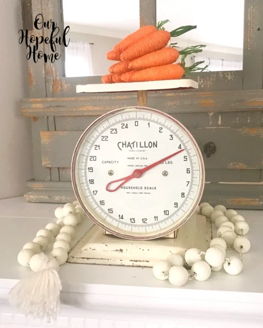 farmhouse scale with patina and orange carrots