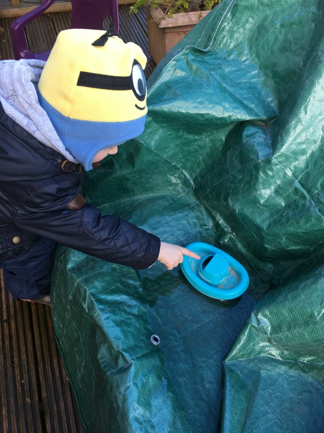our-weekly-journal-27-march-toddler-playing-with-plastic-boat-in-puddle-of-water