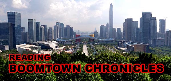 wide view of an urban area with bushes in the foreground, over which is written "READING BOOMTOWN CHRONICLES"
