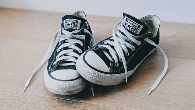 Black and white trainers on the floor