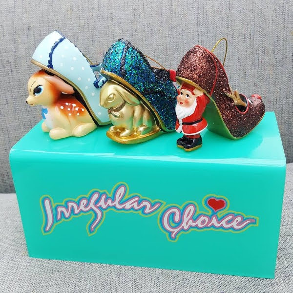 deer, rabbit and Santa heeled shoe Christmas baubles on Irregular Choice display stand