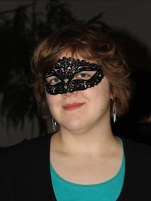 young woman wearing black lacy mask