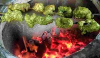 Cooking hariyali kabab over a charcoal tandoor