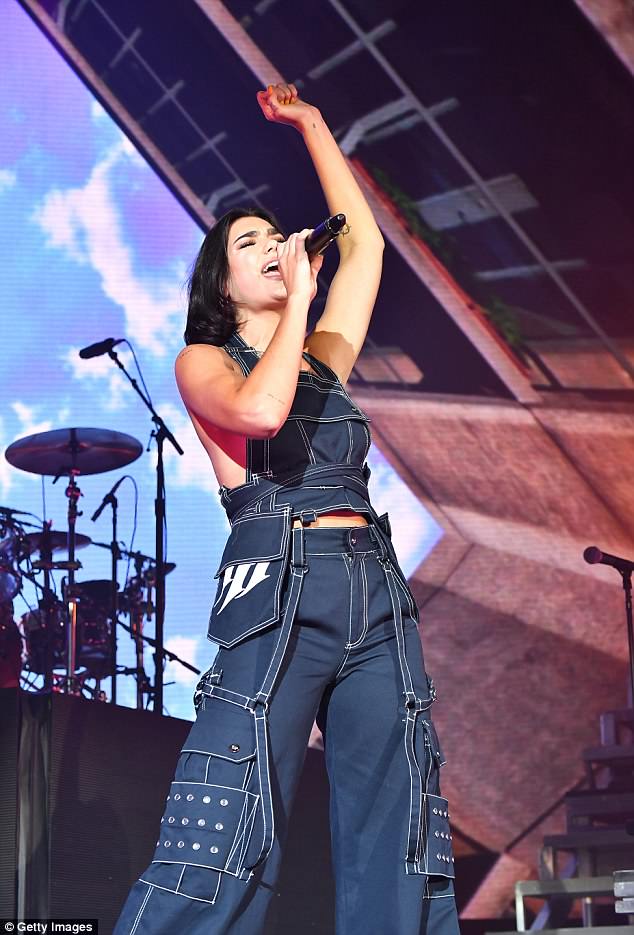 Dua Lipa goes braless in denim jumpsuit in Atlanta
