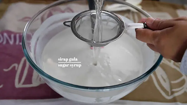 Add coconut milk to kuih lapis batter