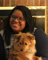 A photo of me, Alison. My small pomchi Ruger is sitting in my lap.