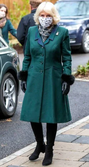 The Duchess of Cornwall is patron of the charity Battersea. Battersea introduced online puppy training classes. The Duchess wore a green wool coat