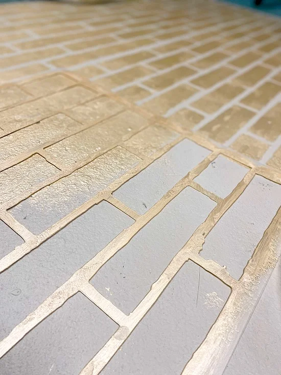 stenciled metallic bricks with a stencil