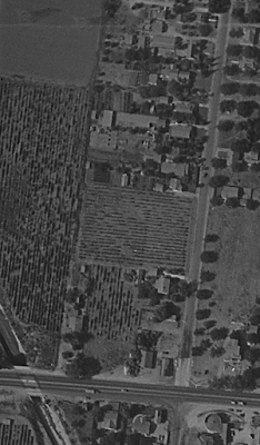 A black-and-white aerial photo of a rural area.