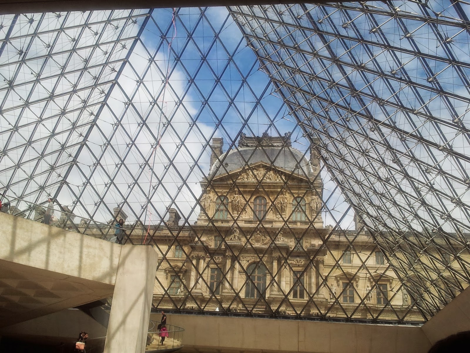 Looking out under the glass at the Louvre, Paris.