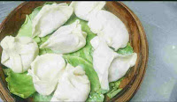 Chicken momos over cabbage leafs on momo basket