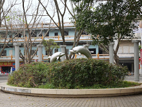 sculpture of dolphins next to the Jiangmen River in Jiangmen