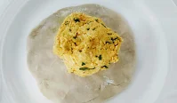 Paneer mixture at the centre of flatten dough for paneer paratha recipe