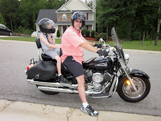 a photo of David brodosi and his son going for a motorcycle ride