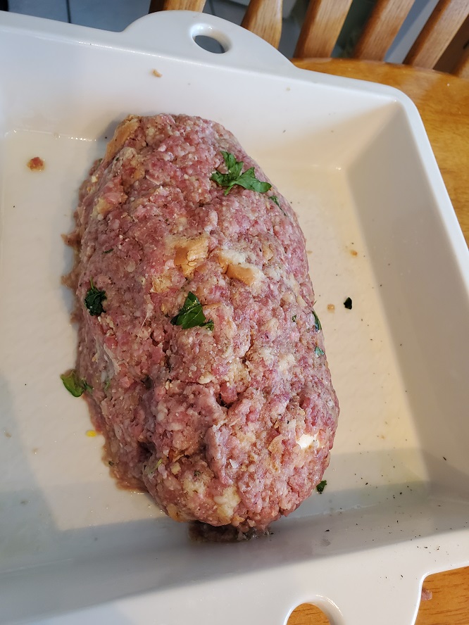 this is a meatloaf raw in a white revol pan