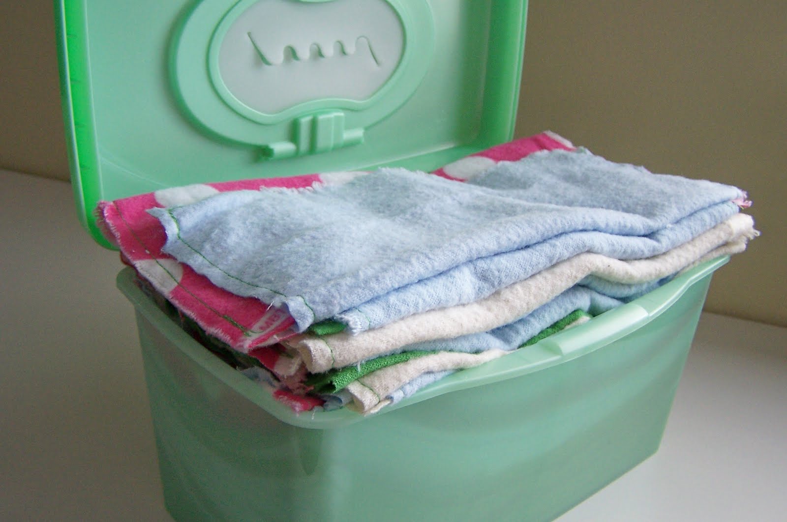 Image of DIY reusable cloth baby wipes in a green plastic container
