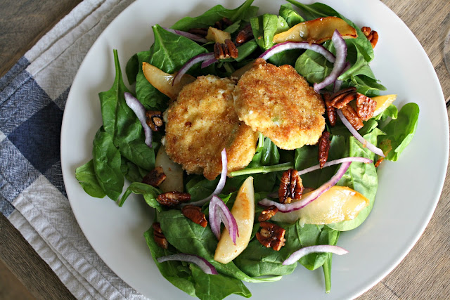 A plate of food on a table, with Salad and Spinach