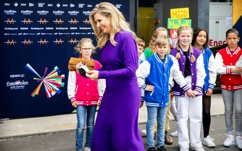 Queen Maxima wore a puffled sleeves dolman midi dress from Victoria Beckham, and yellow floral print silk satin dress from Natan