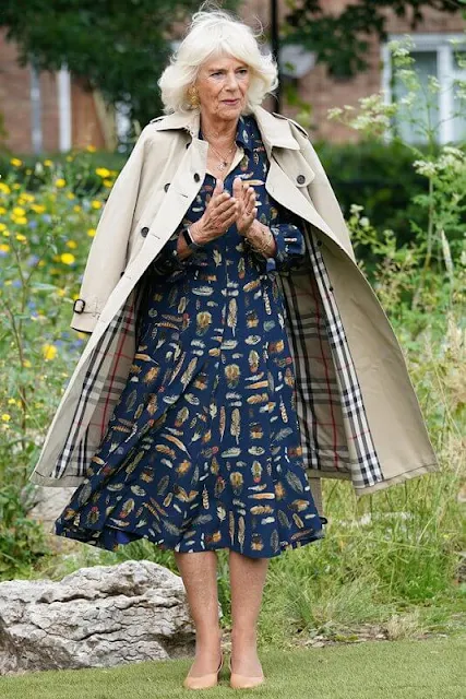 The Duchess of Cornwall wore a navy blue, feather-print dress from Fiona Clare