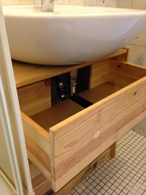 cut out dresser drawers to fit pipes 