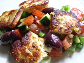 Fried Saganaki with Halloumi on a Greek Tomato Salad with Kalamata Olives