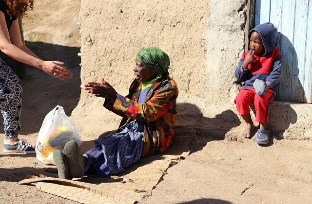 woman helping poor people in Africa