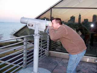 Jerry Yoakum looking through a sight-seeing telescope at Adler Planetarium in Chicago.