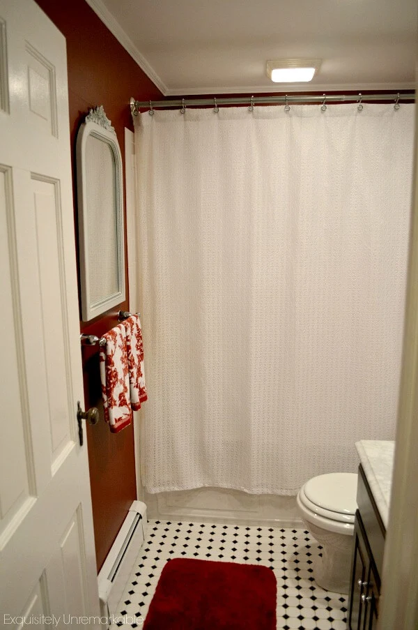 White Bathroom Mirror against red walls