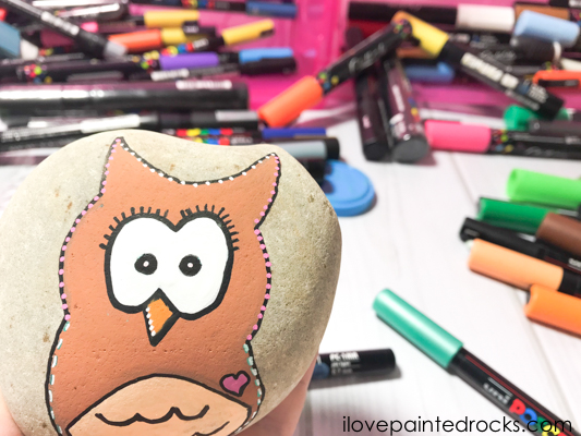A owl painted rock which is super cute and easy to make with this step by step tutorial