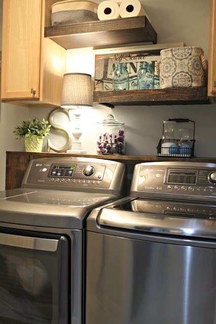 Wood shelf behind washer and dryer