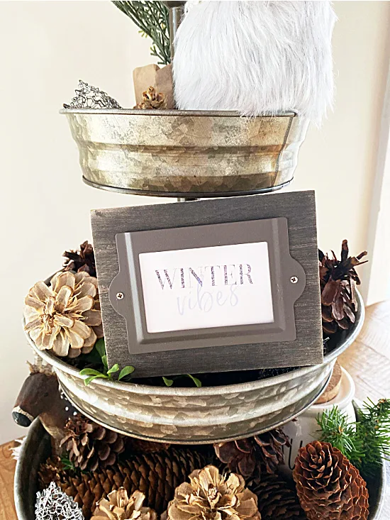 tray full of pinecones and a winter vibes sign