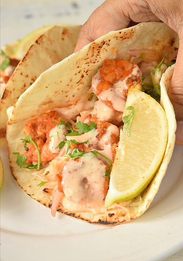 spicy shrimp tacos with sour and sweet sauce and cabbage slaw